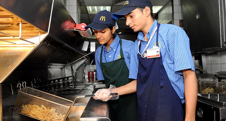 Crew members working the fry station