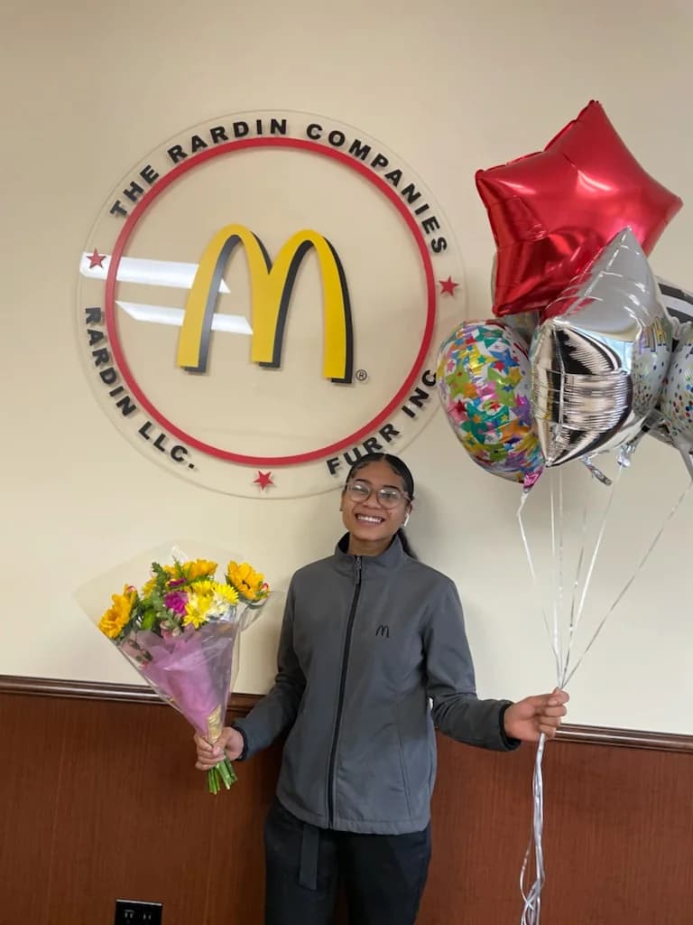 A team member being celebrated at the support office
