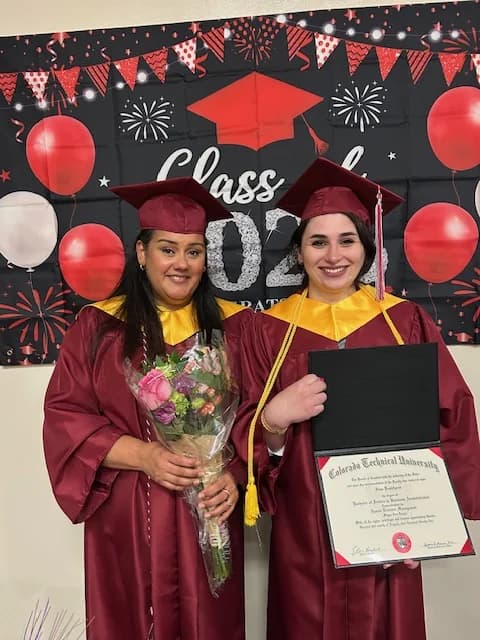 Two team members celebrating their graduation